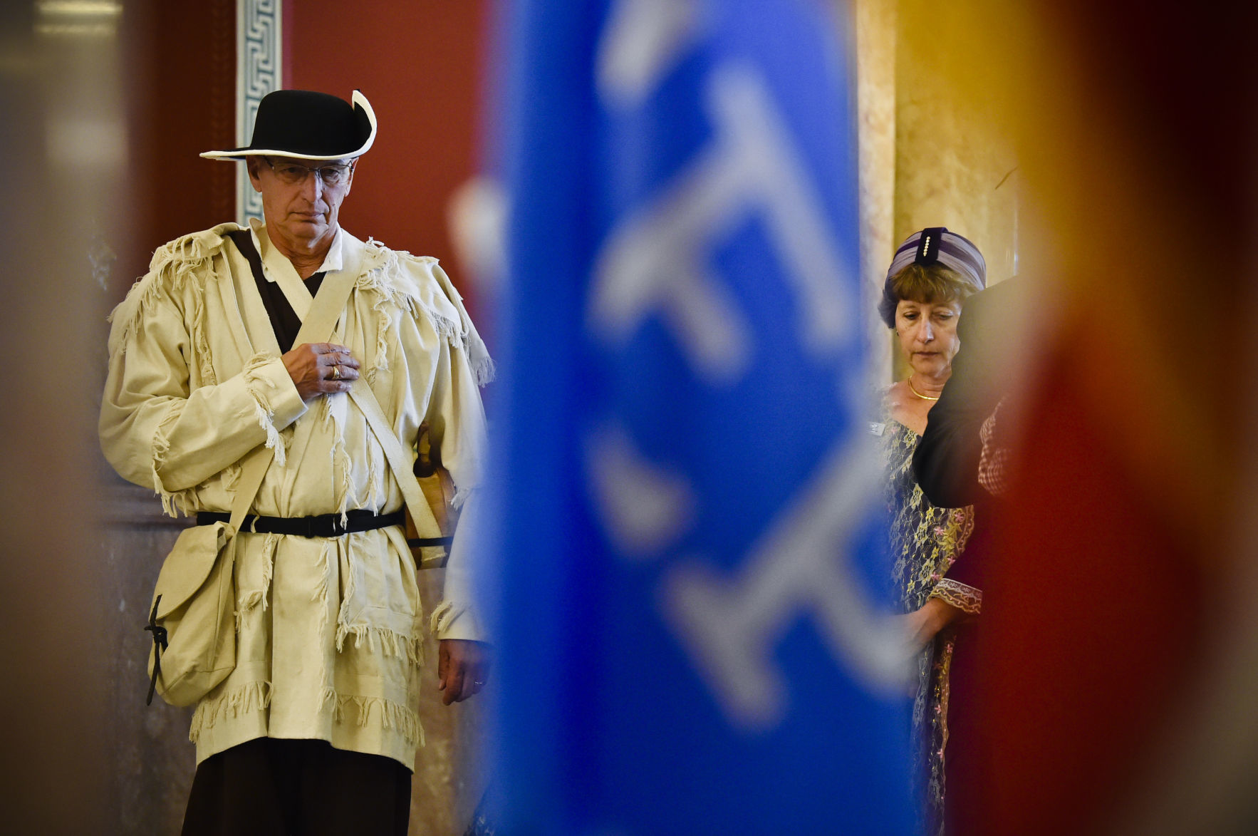 Event attendants hang their head during the invocation